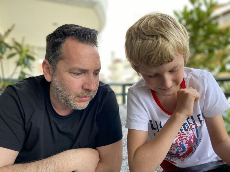 Father and son playing table game